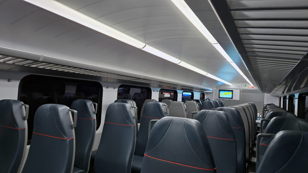 Dark blue seats and grey panel train interior.