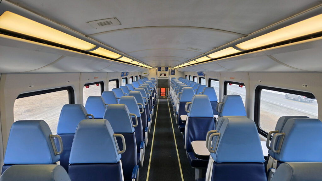 Double seats of seats on a train in two tones of blue.