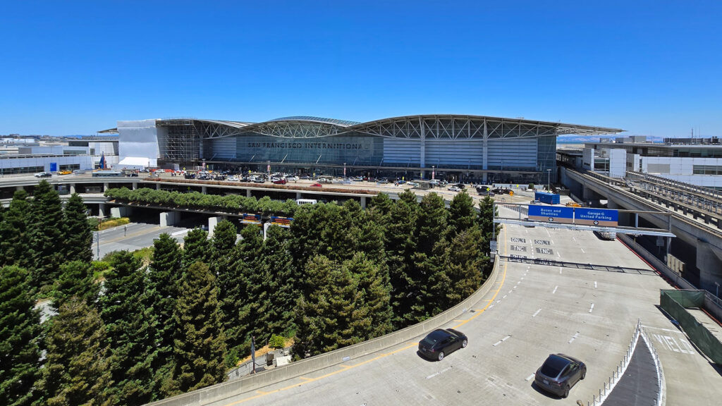 Massive, modern structure of metal and glass with the word San Francisco International in large letters on the side of the building.